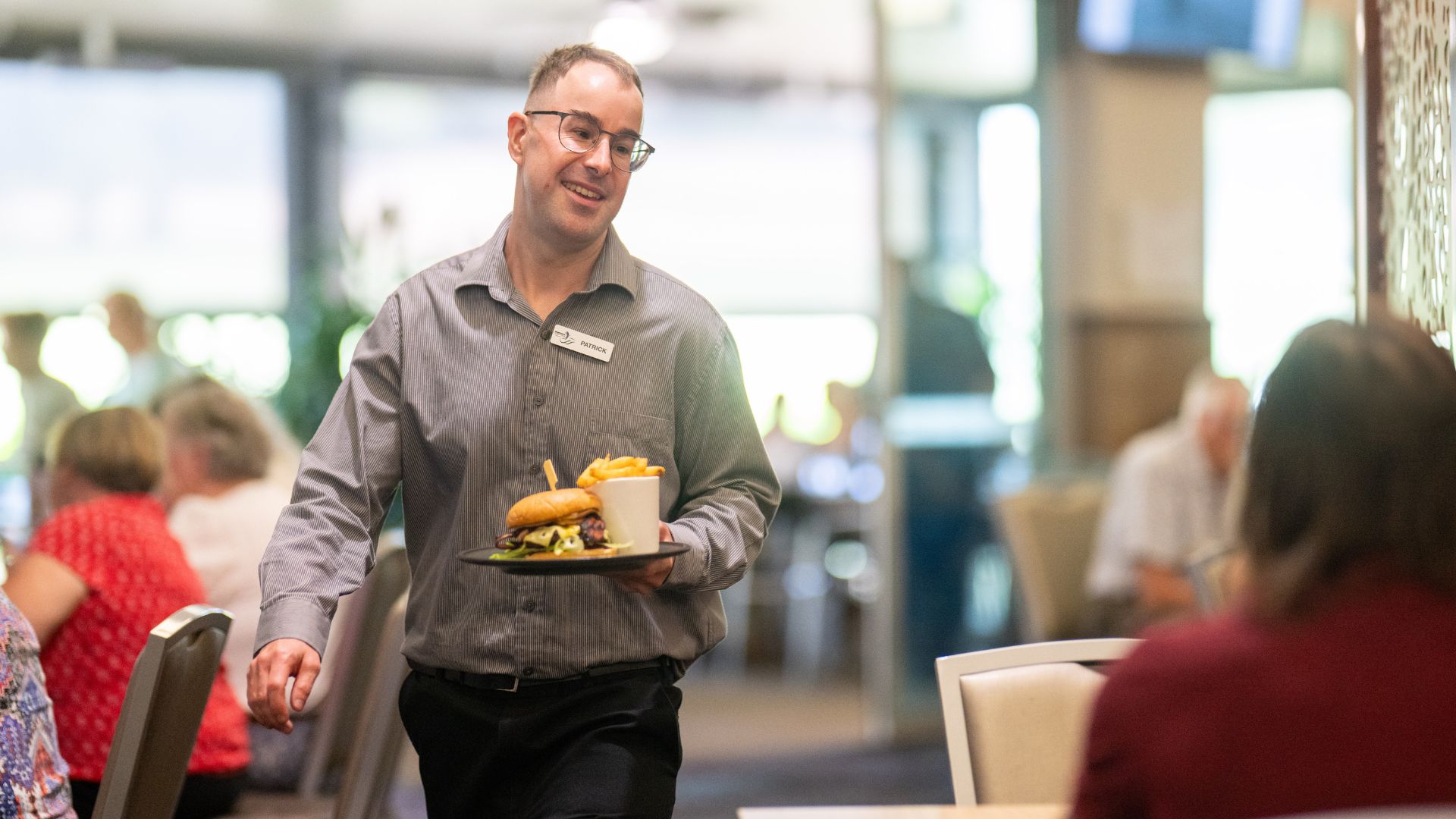 Pat serving food with a smile in the bistro